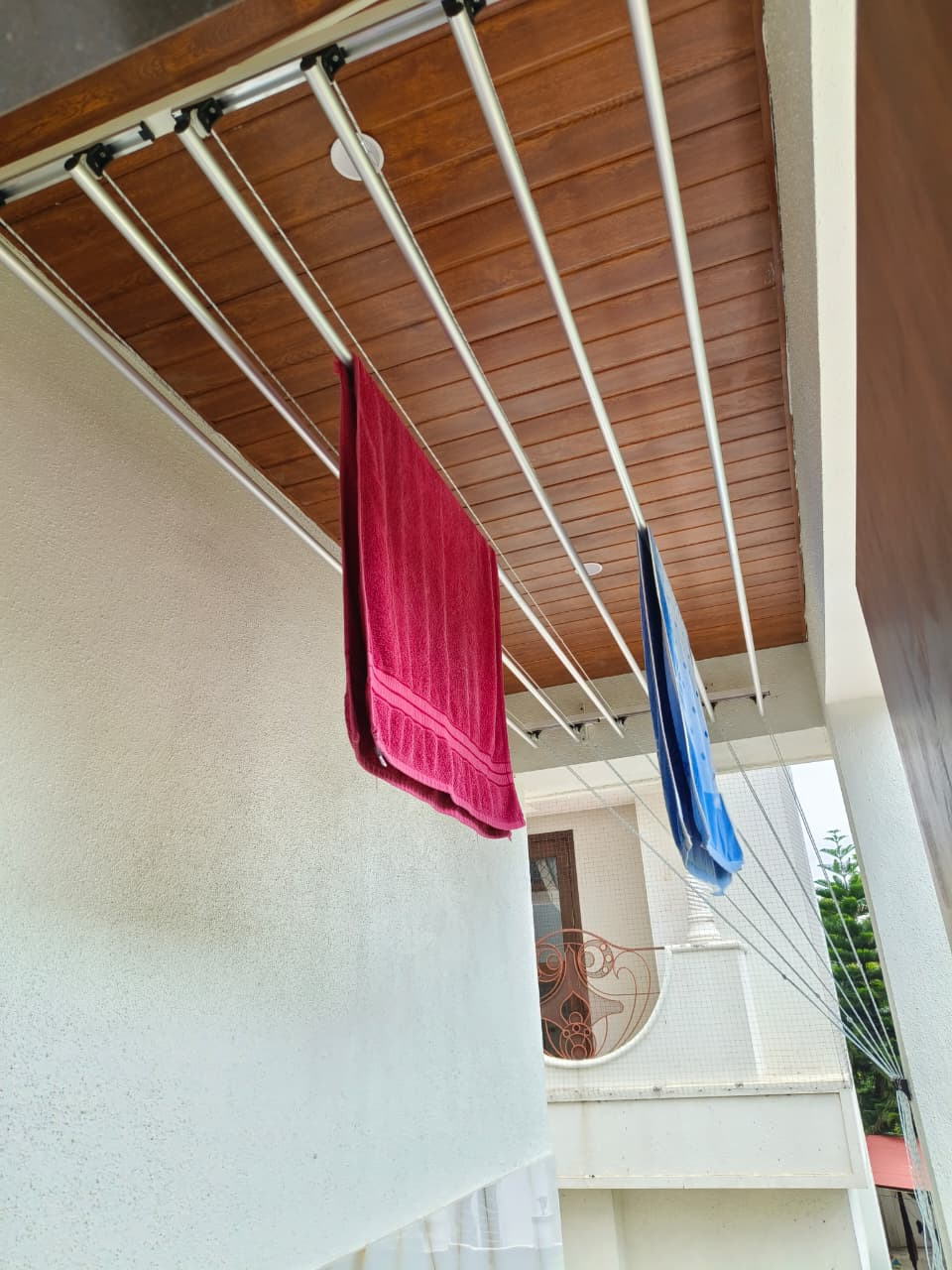 Ceiling mounted pulley cloth drying system installed in Pune apartment balcony by Excellent Interior Solutions
