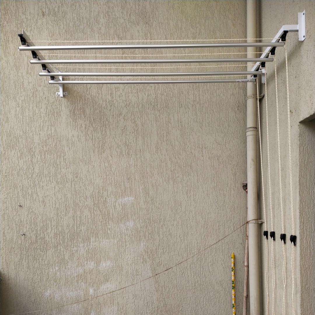 Wall mounted foldable cloth drying stand installed in Pune terrace by Excellent Interior Solutions